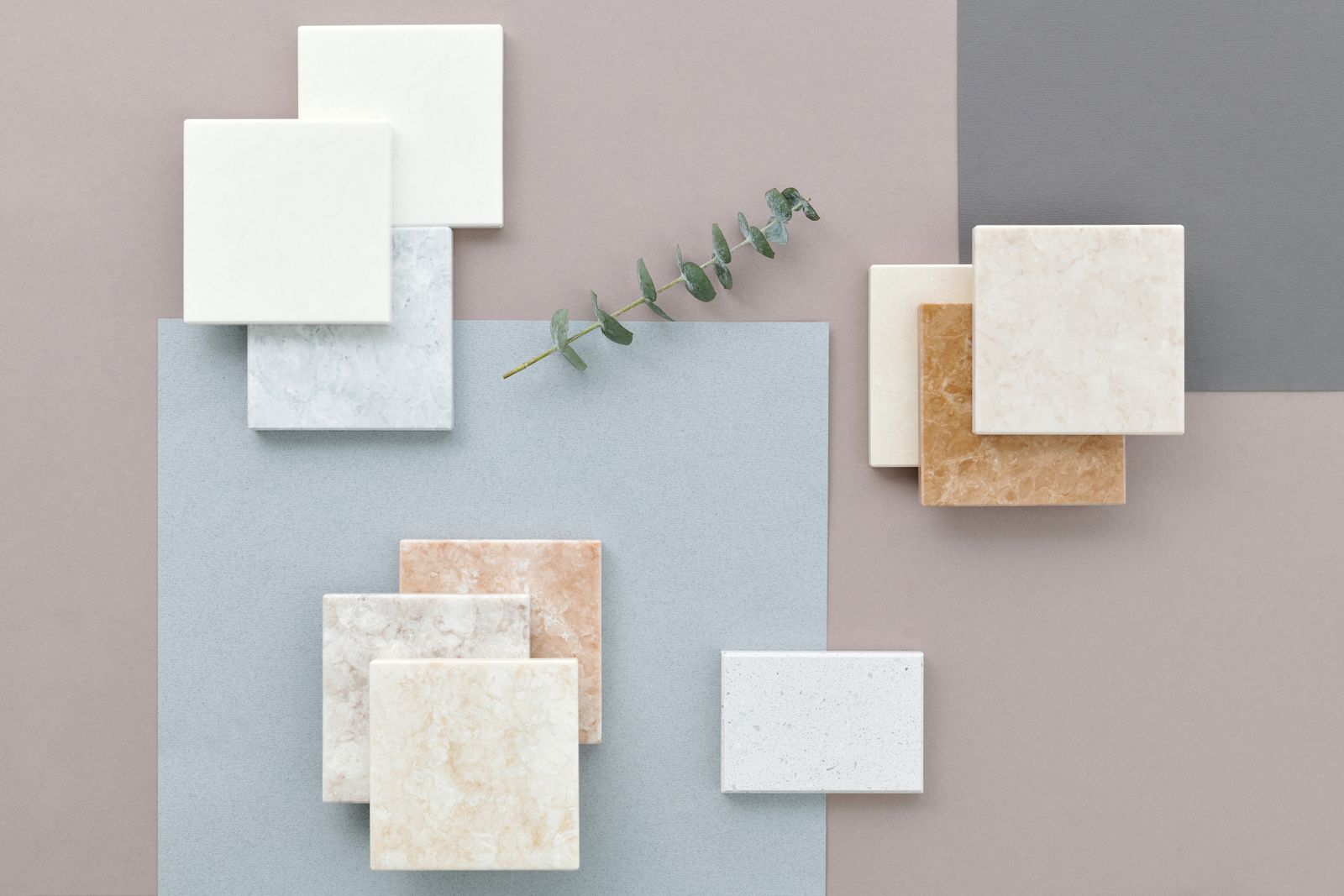 Marble and ceramic tile samples laid out for a bathroom selection.