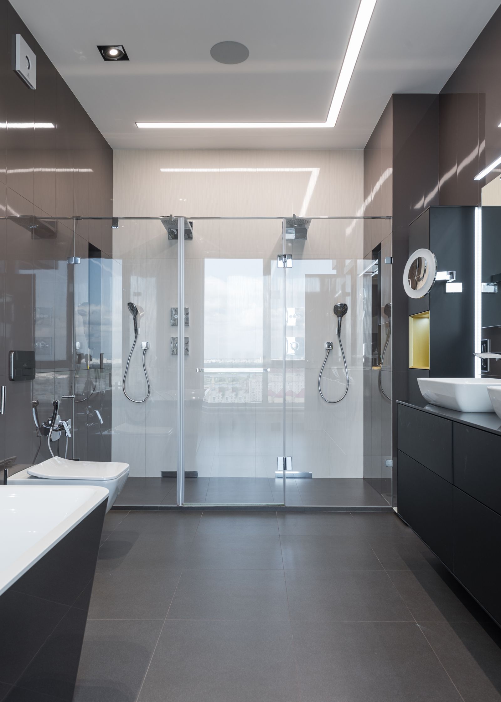 A frameless glass shower enclosure set against a tiled wall.